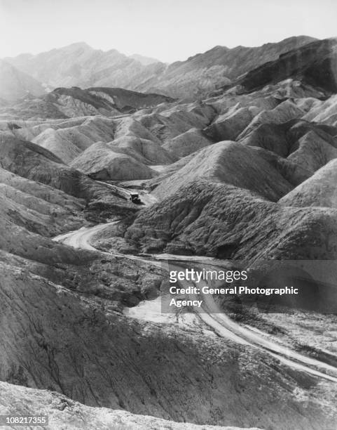Car makes its way down a track in Corkscrew Canyon, Death Valley, California, 1929.