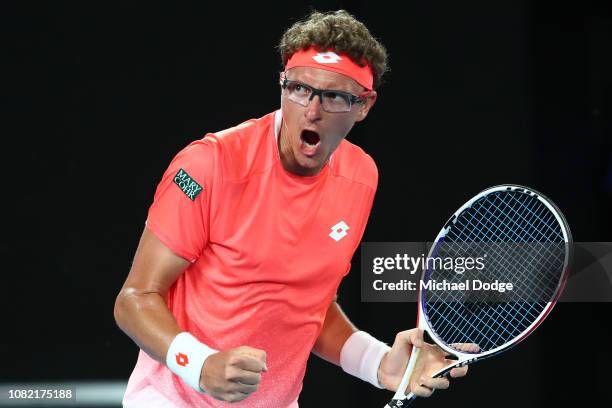 Denis Istomin of Uzbekistan celebrates in his first round match against Roger Federer of Switzerland during day one of the 2019 Australian Open at...