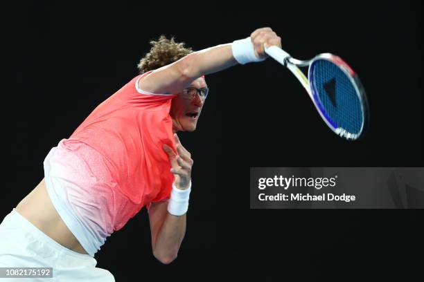 Denis Istomin of Uzbekistan serves in his first round match against Roger Federer of Switzerland during day one of the 2019 Australian Open at...