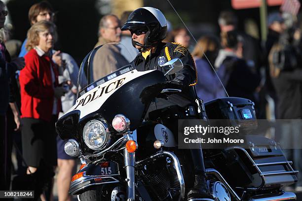 Tucson police escort the ambulance of U.S. Rep. Gabrielle Giffords , as she is transferred from the University Medical Center for rehabilitation in...