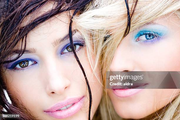 two women wearing make-up and smiling close together - blå ögonskugga bildbanksfoton och bilder
