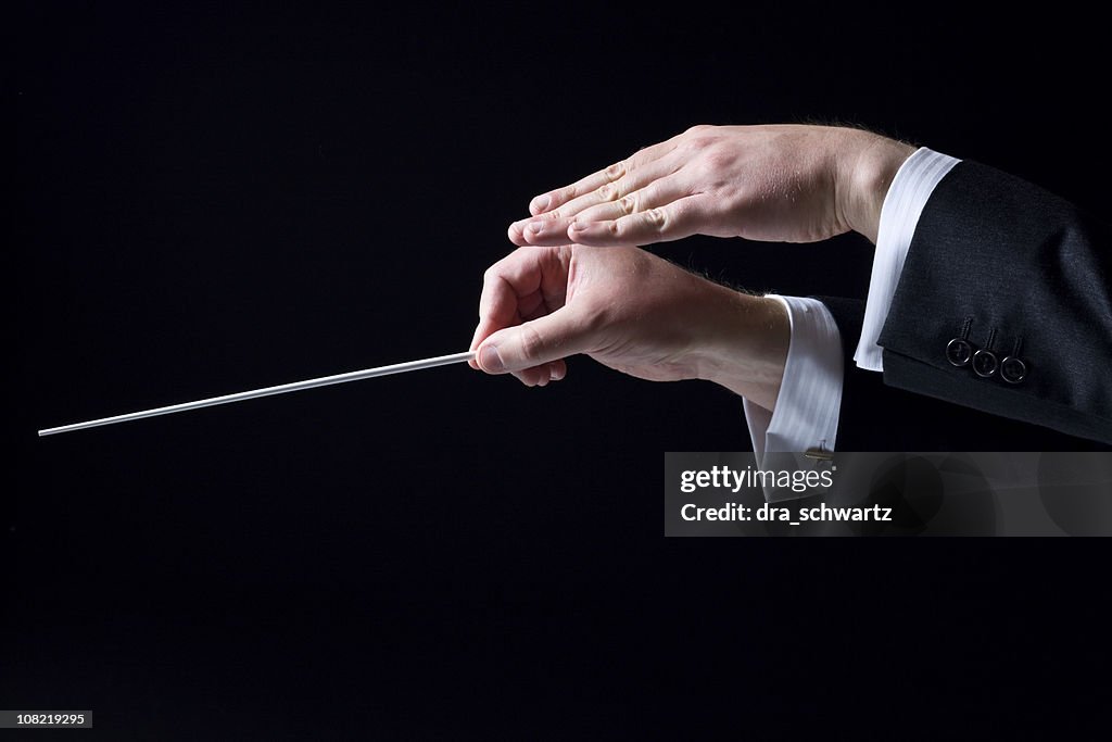Closeup Of Orchestra Conductors Hands Isolated On Black High-Res Stock ...