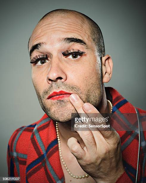 young man fixing lipstick - man make up stock pictures, royalty-free photos & images
