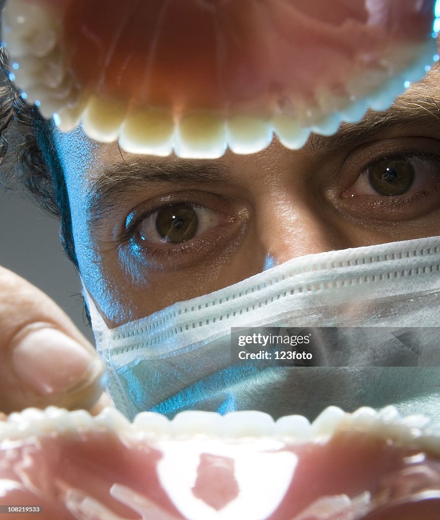 View of Dentist Examining Teeth From Open Mouth