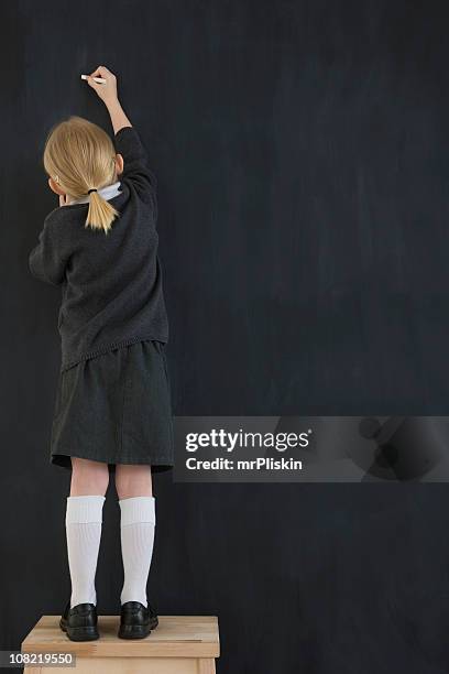 giovane bambino scrivendo su un chalkboard - gessetto da lavagna foto e immagini stock