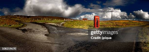 red telephone booth rural landscape - telephone booth stockfoto's en -beelden