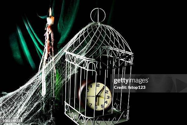 clock in birdcage, candle bottle spider web - inside of a clock stock pictures, royalty-free photos & images