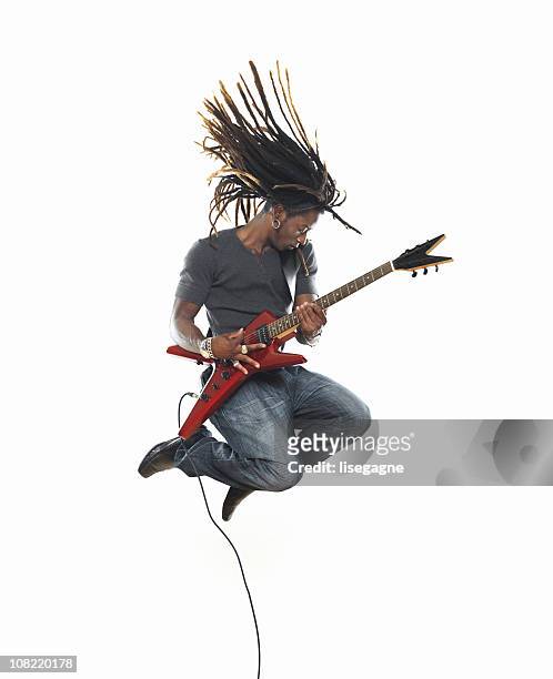 man playing electric guitar and jumping - musician stock pictures, royalty-free photos & images