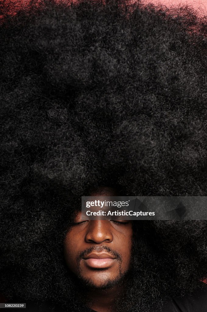 Young Man With Huge Afro Hairstyle Closing Eyes