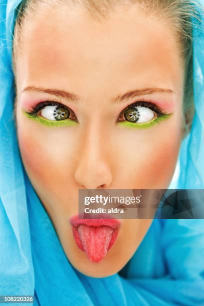 young woman cross eyes and sticking tongue out - eye make up stock pictures, royalty-free photos & images