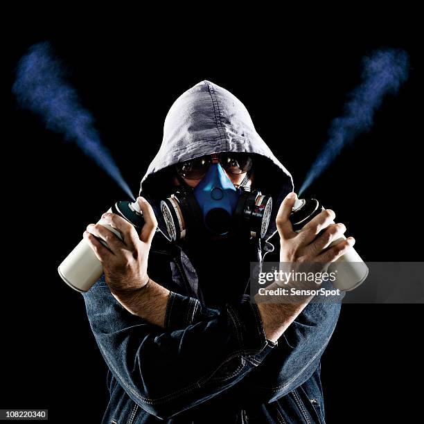 man holding graffiti spray paint cans - grafitti artist stock pictures, royalty-free photos & images