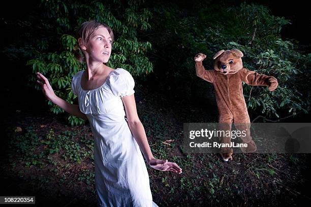 costumed bear chasing a young woman - chase stock pictures, royalty-free photos & images