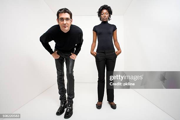 man and woman standing in mysterious white space - cool man leather stock pictures, royalty-free photos & images