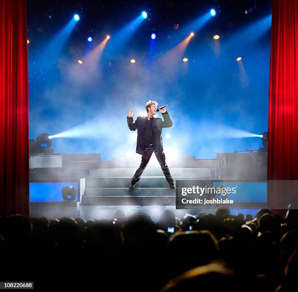 singing rock star - male singer stock pictures, royalty-free photos & images