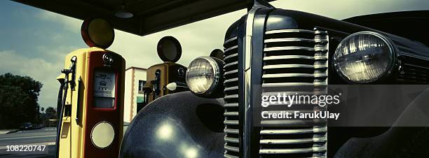 retro scene with vintage gas pumps and car - radiator grille stock pictures, royalty-free photos & images