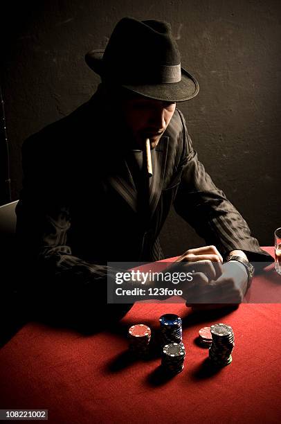man smoking cigar at card table with poker chips - vintage harlem new york stockfoto's en -beelden
