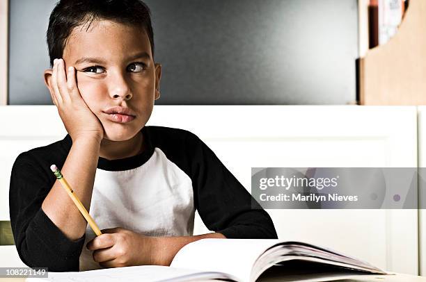 bored boy doing homework - child writing on chalkboard stock pictures, royalty-free photos & images