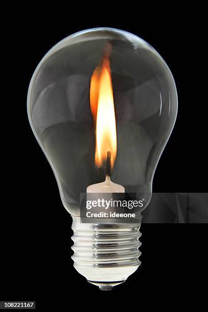 candle inside light bulb - blackout stock pictures, royalty-free photos & images