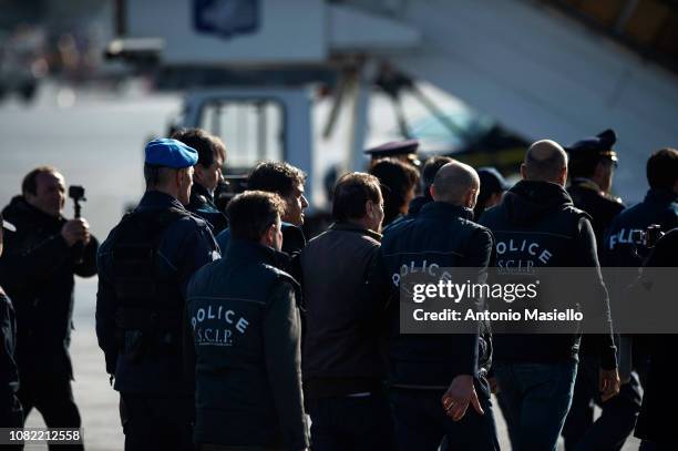 Italian former far-left activist Cesare Battisti is escorted by Italian Police officers upon his arrival at Ciampino airport on 14 January, 2019 in...