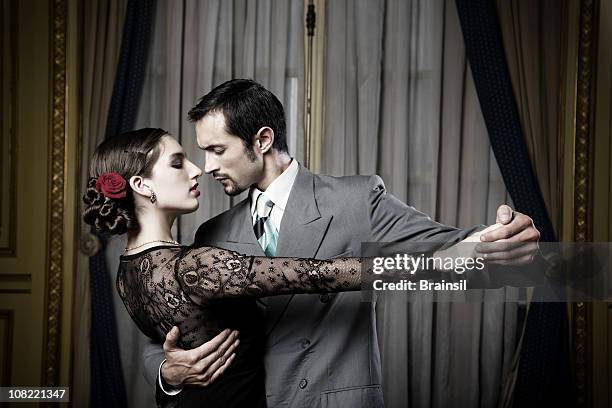 young couple doing tango dance in room, low key - tango black stock pictures, royalty-free photos & images