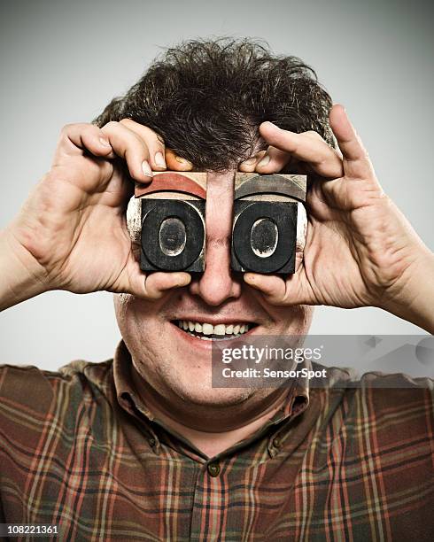 man holding wooden stamps to eyes - comic style font stock pictures, royalty-free photos & images