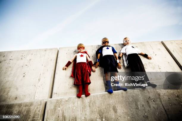 tight spot - child superhero stock pictures, royalty-free photos & images