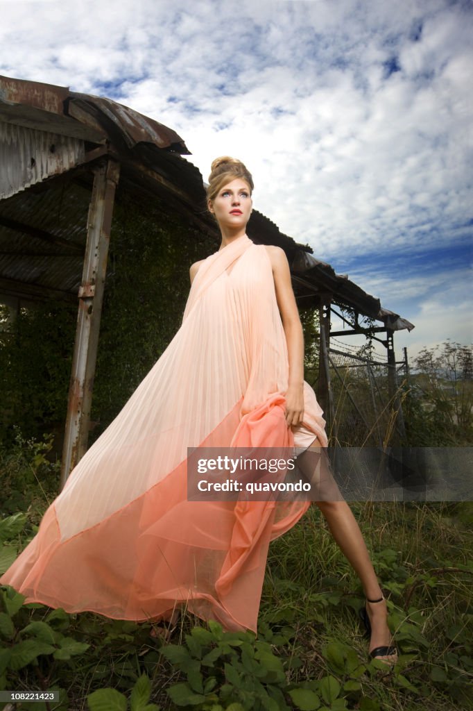 Beautiful Caucasian Fashion Model Outside in Flowing Pink Dress