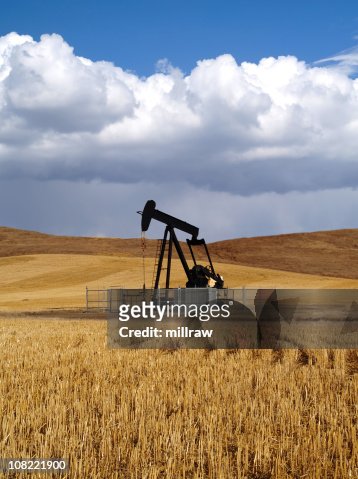 Black Oil Well Pumpjack With Storm Approaching