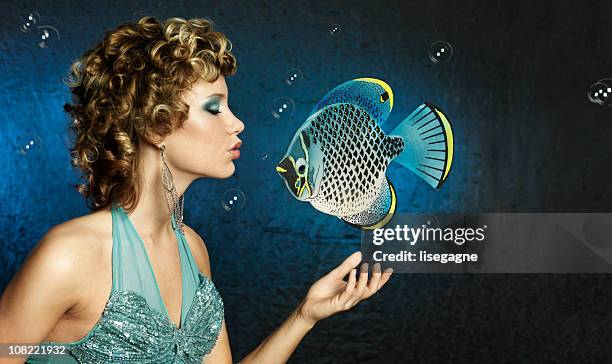 mermaid woman kissing fish - fantasy mermaid stock pictures, royalty-free photos & images