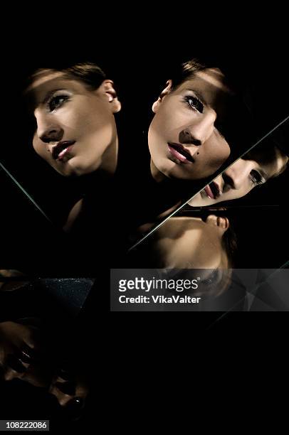 mirrored - multiple images of the same woman stock pictures, royalty-free photos & images