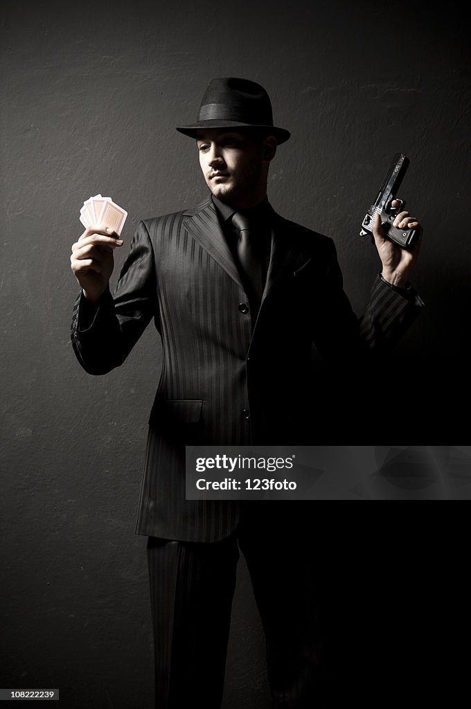 Gangster Man Holding Gun And Hand Of Cards High-Res Stock Photo - Getty  Images