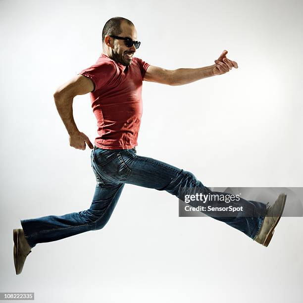 young man playing air guitar - air guitar stockfoto's en -beelden