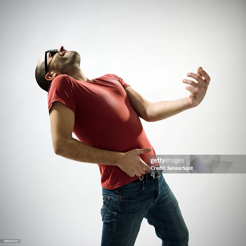 Young man playing air guitar