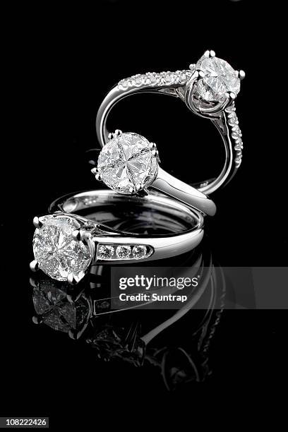 three white gold diamond rings on black background - diamond ring stock pictures, royalty-free photos & images