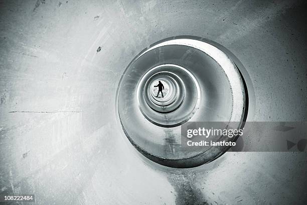 figure in a cement tunnel. - claustrophobia stock pictures, royalty-free photos & images