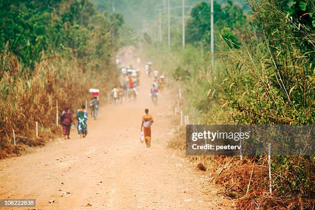 people walking down road in africa - togo stock pictures, royalty-free photos & images