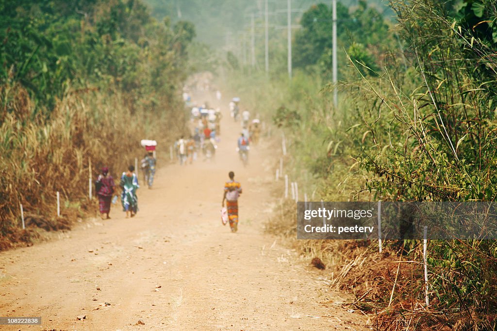 People Walking Down Road in Africa