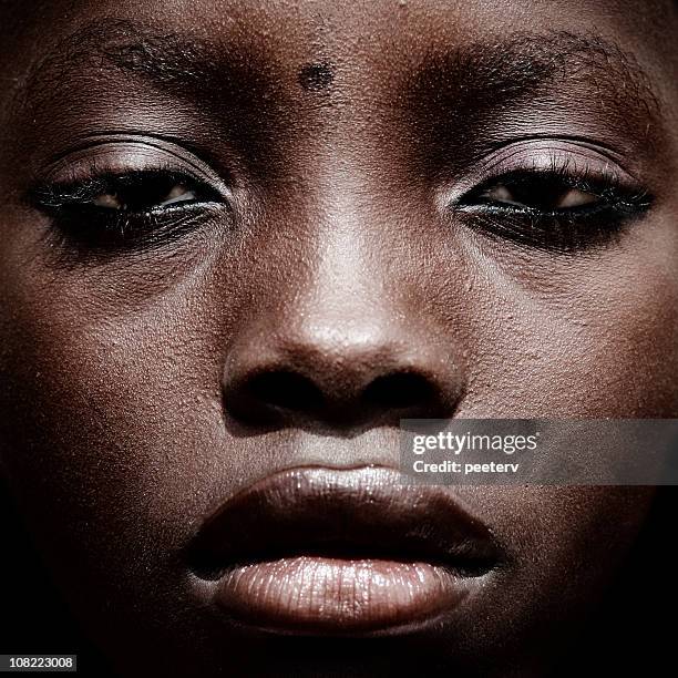 close-up of serious woman's face - nigerian girls stock pictures, royalty-free photos & images