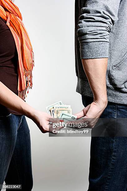 man and woman exchaning wad of money - hiding money stock pictures, royalty-free photos & images