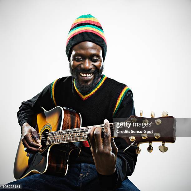 rastafarian man playing guitar - black guitarist stock pictures, royalty-free photos & images