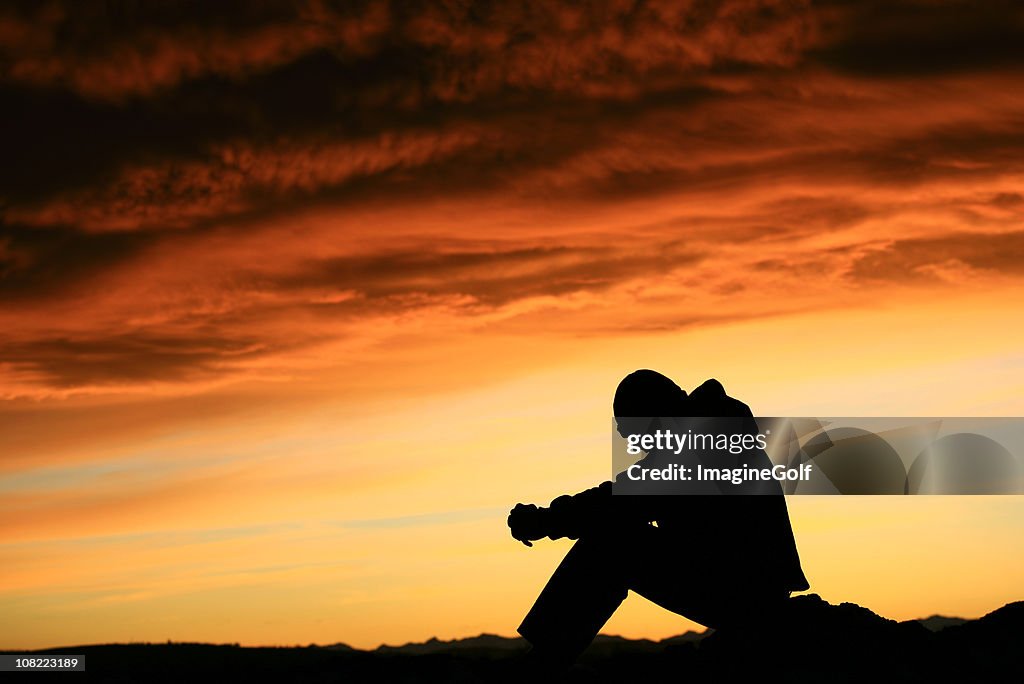 Silhouette of Young Man Contemplating Life
