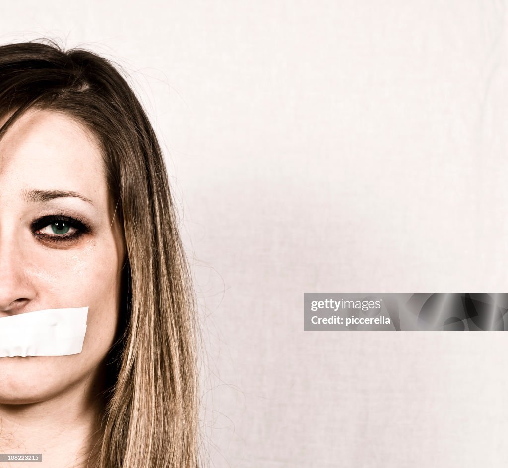 Shut up concept of woman with tapes mouth