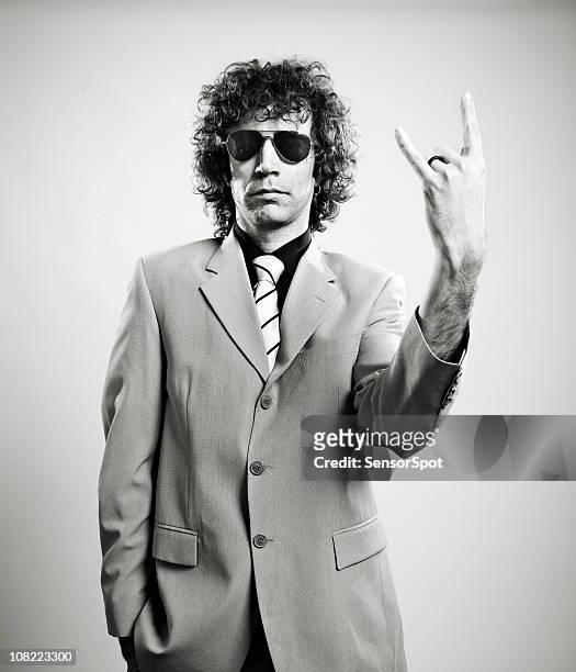 trendy man giving rock sign - alternative rock stock pictures, royalty-free photos & images