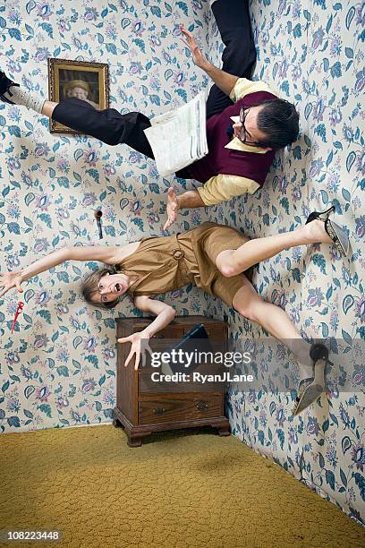 man and woman falling through the air in living room - vrouw behangen stockfoto's en -beelden