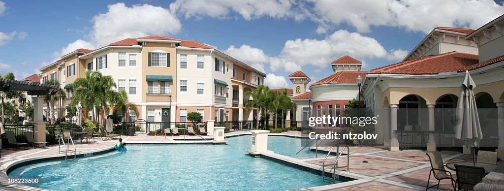 Modern apartment complex with pool and patio areas