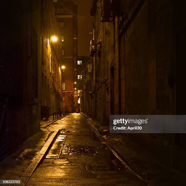 dark alleyway with light in downtown glasgow - dark street stock pictures, royalty-free photos & images