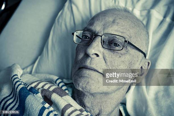 sick, senior man lying in hospital bed - cancer patient portrait stock pictures, royalty-free photos & images