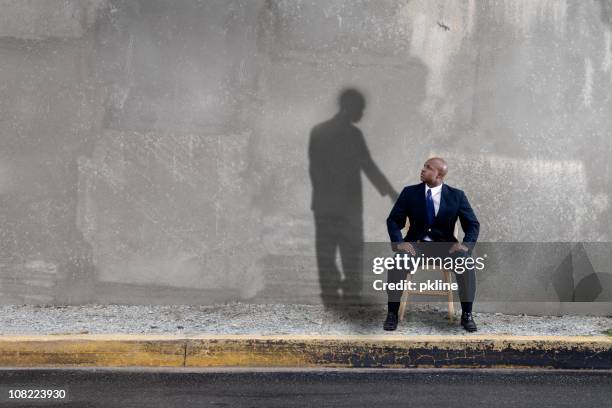 shadow watching over man - restraining stock pictures, royalty-free photos & images