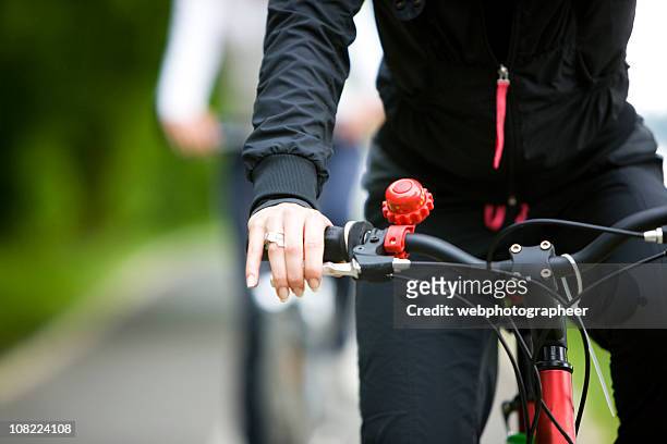 woman riding a bike - handlebar stock pictures, royalty-free photos & images