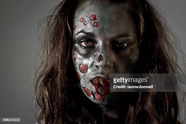 zombie relamerse el labio - zombie face fotografías e imágenes de stock